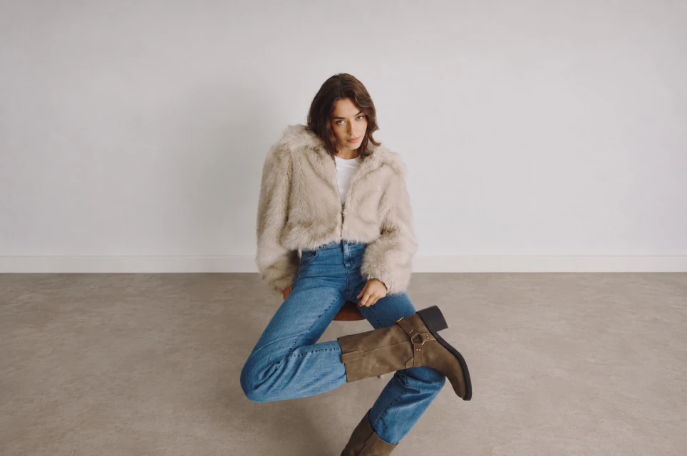 Model trägt blaue Wide Leg Jeans von ANGELS mit Felljacke und Stiefeln
