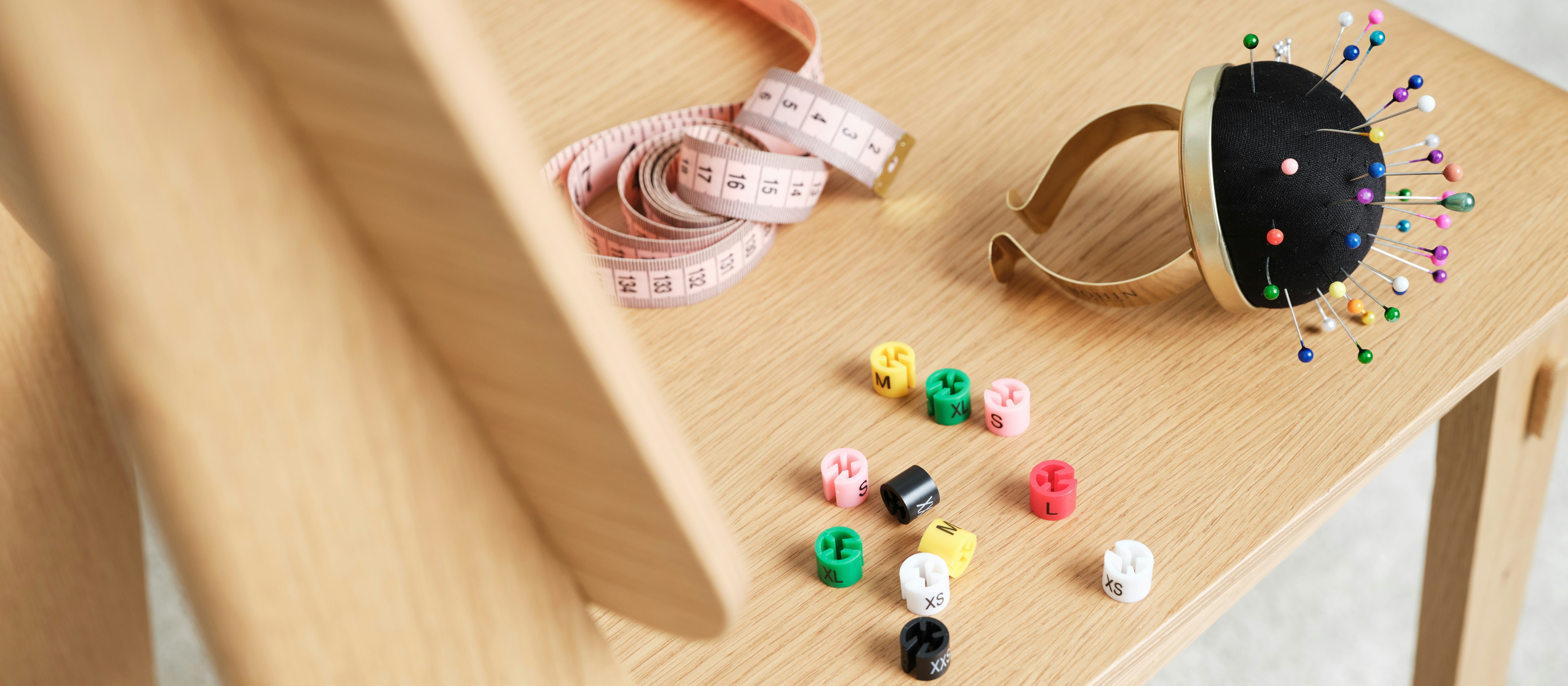 Maatband en maatclips op kledinghangers als symbool voor de Bonita kleding maattabel.