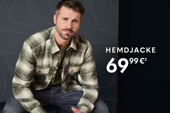 Thore trägt eine grün-beige karierte CASAMODA Herren-Hemdjacke mit Brusttaschen, kombiniert mit einem grünen T-Shirt und blauer Jeans.