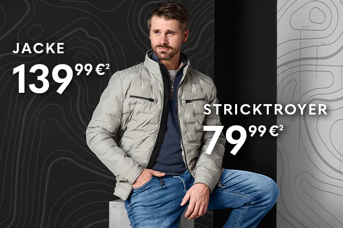 Thore Schölermann trägt eine beige Herrenjacke mit Stehkragen, blauem Pullover und Jeans.