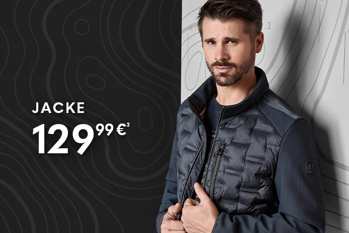 Thore trägt eine dunkelblaue Steppweste über einem Langarmshirt und Jeans.