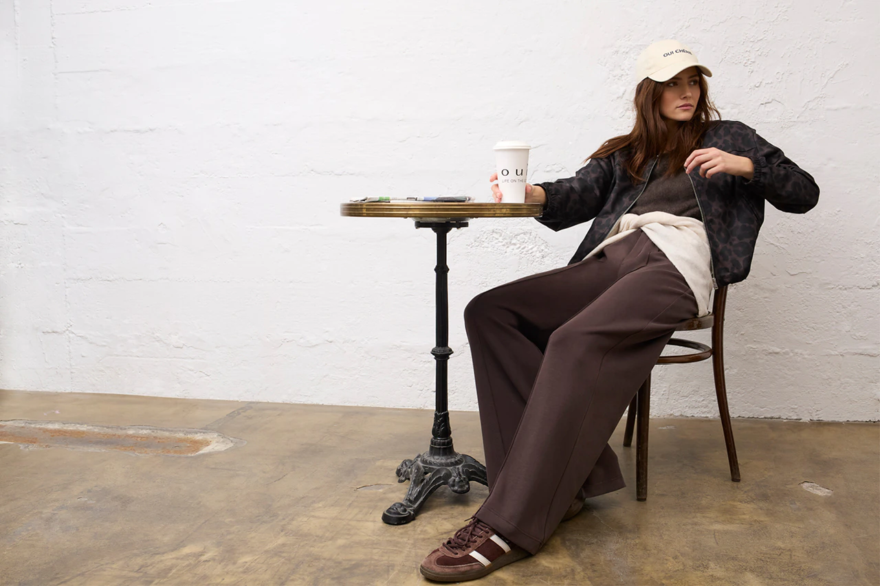 Women’s fashion from Oui, featuring a leopard-print jacket, a knitted jumper, a cardigan and trousers.