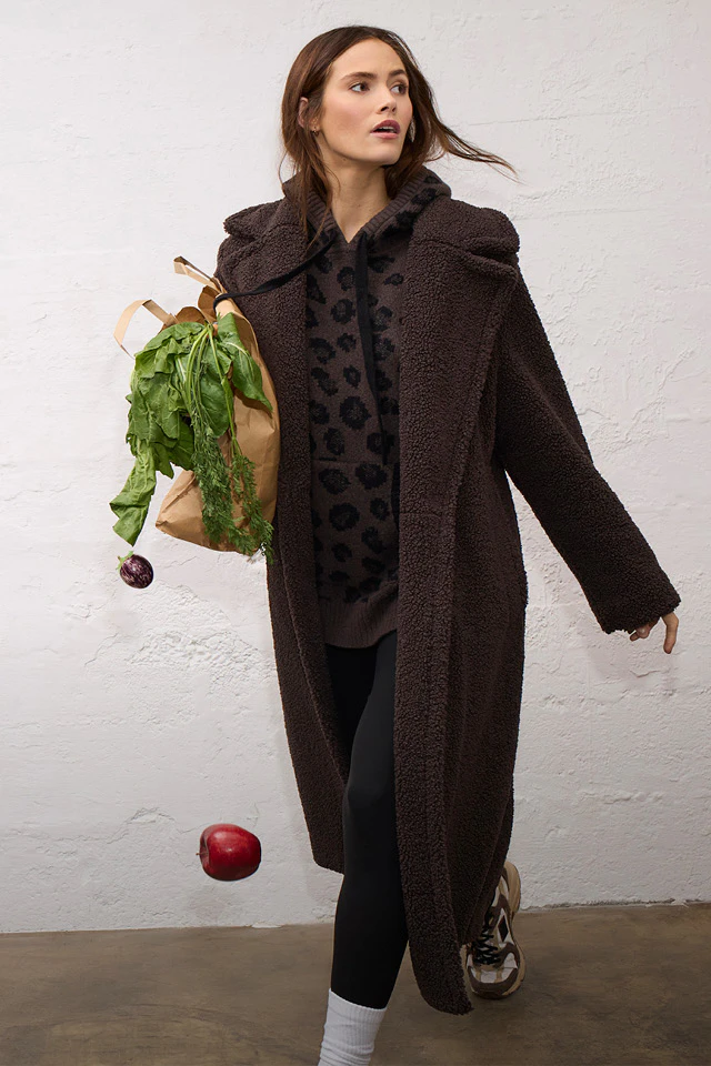 Women’s fashion from Oui, featuring a teddy coat, a knitted hoodie and trousers from the latest collection.
