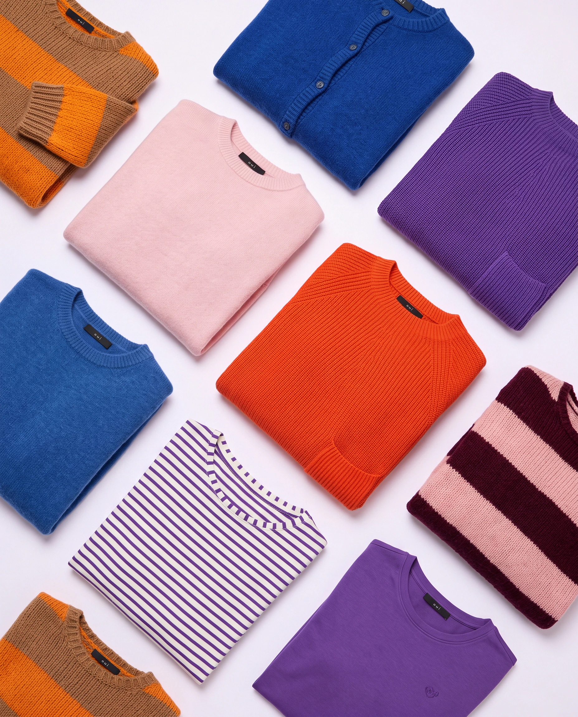 Oui Essentials: A selection of coloured jumpers, cardigans and striped tops in blue, pink, orange, purple and burgundy.