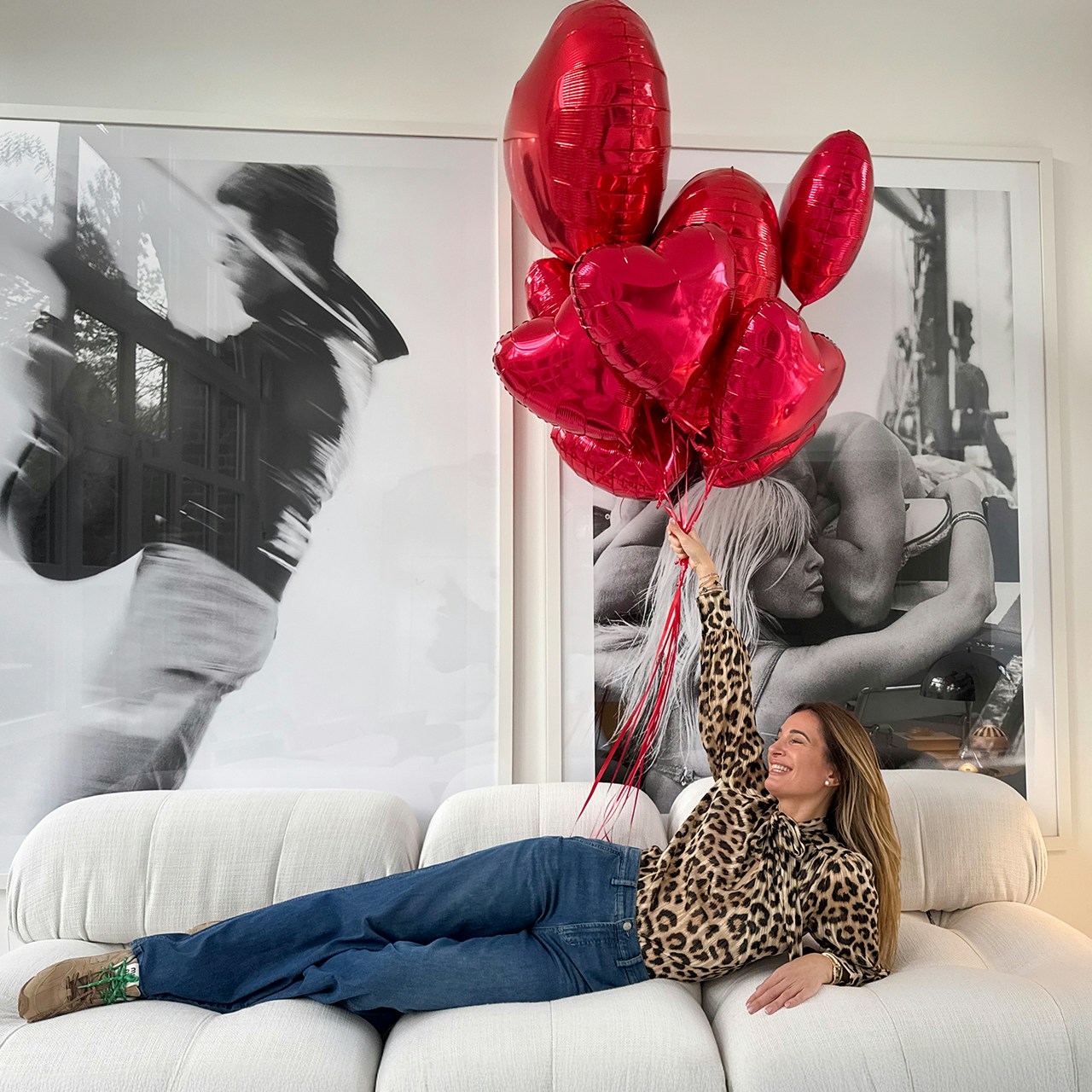 Lena trägt unsere Leo Bluse mit einer einfachen Denim. Dazu hält sie mehrere rote Herz Luftballons.