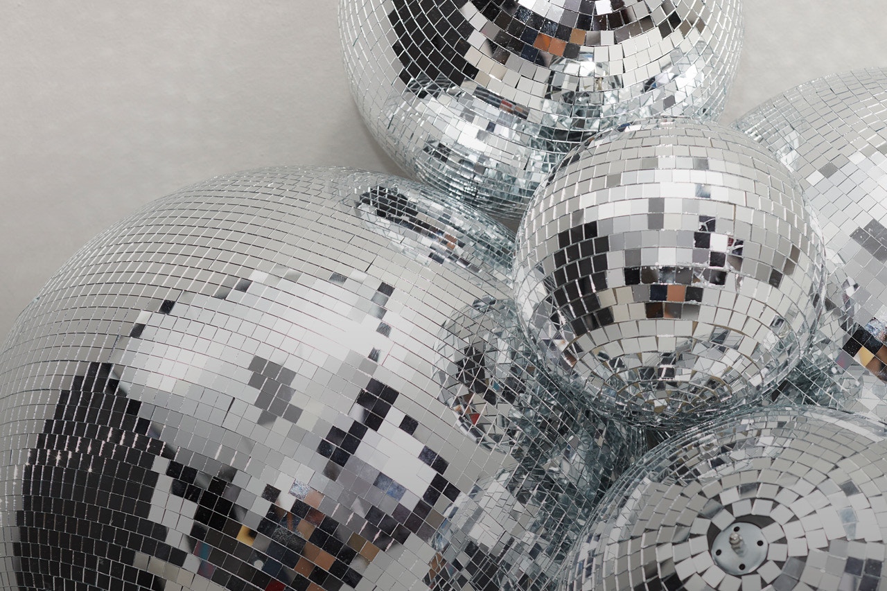 Various disco balls shimmer festively, click on them to be taken to the shop the look page for the Modern Muse collection.