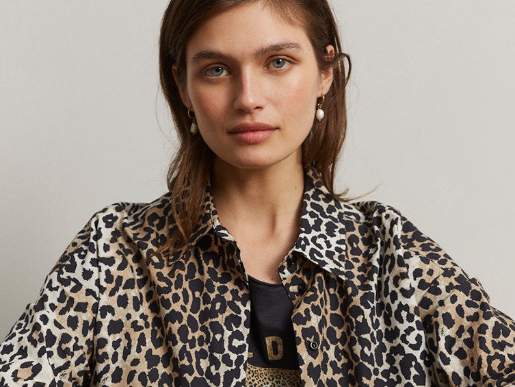 Woman with leo jacket and black T-shirt also with leo elements.