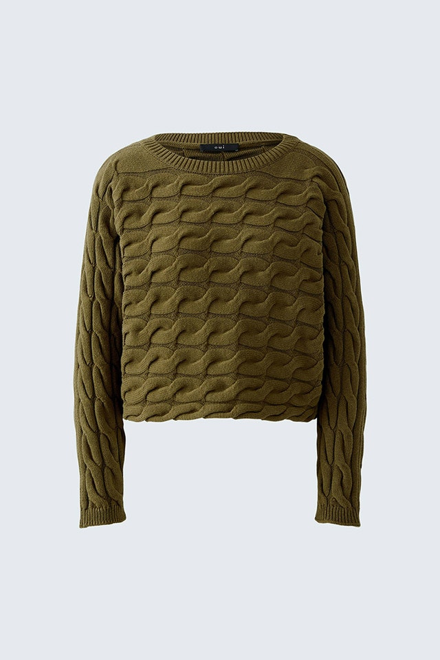 A green knitted jumper with a great pattern.