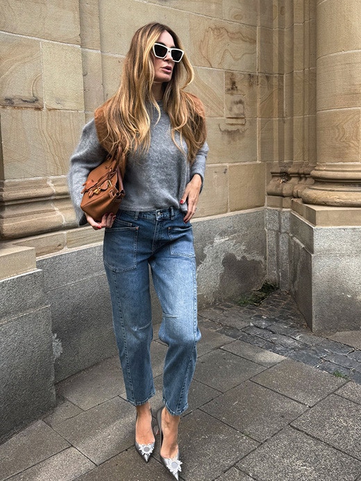 Influencer Lena Terlutter wears our grey cashmere jumper with washed barrel fit jeans.