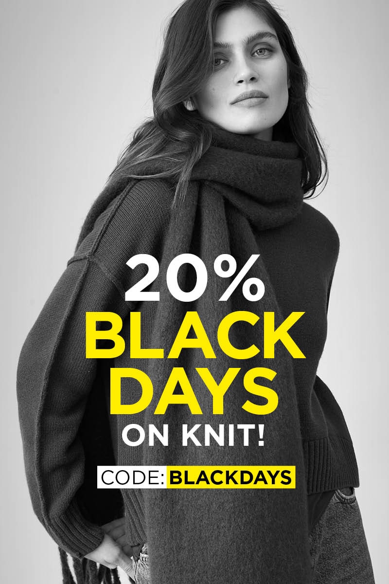 A woman wearing a scarf and jumper in black and white. Yellow and white lettering reads: 20% BLACK DAYS on knit! CODE: BLACKDAYS.