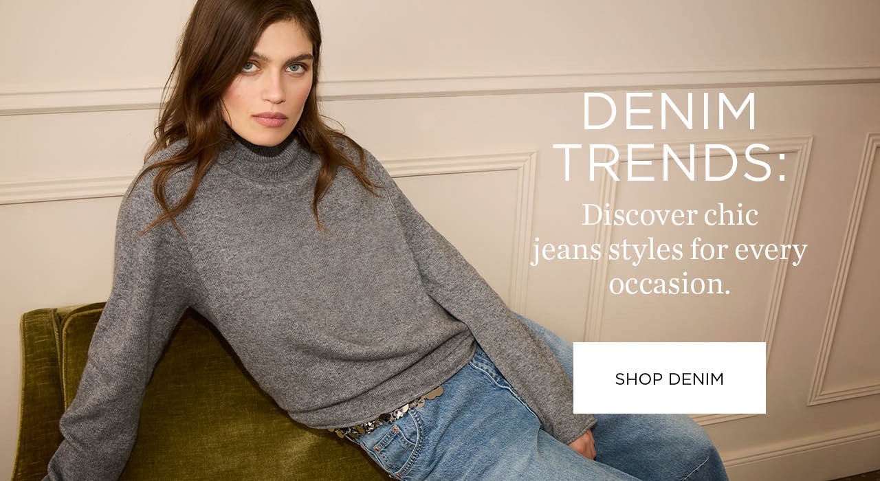 A woman sits casually on the back of a sofa, wearing a grey knitted jumper and jeans. Text on the right: Denim trends: Discover chic jeans styles for every occasion with a clickable area: Shop Denim