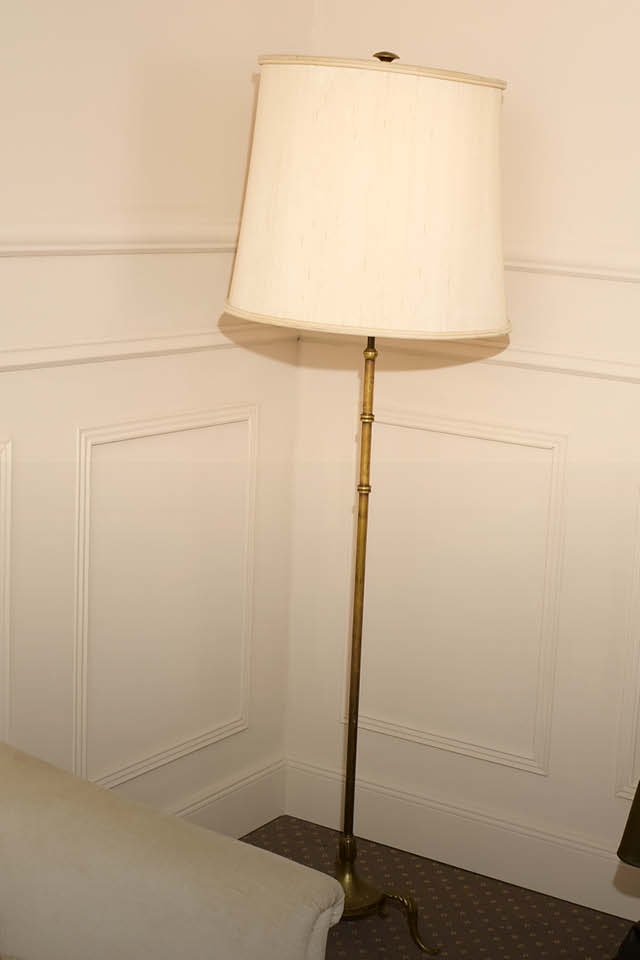 Woman wearing a green jumper and a leather-look skirt, also in green.