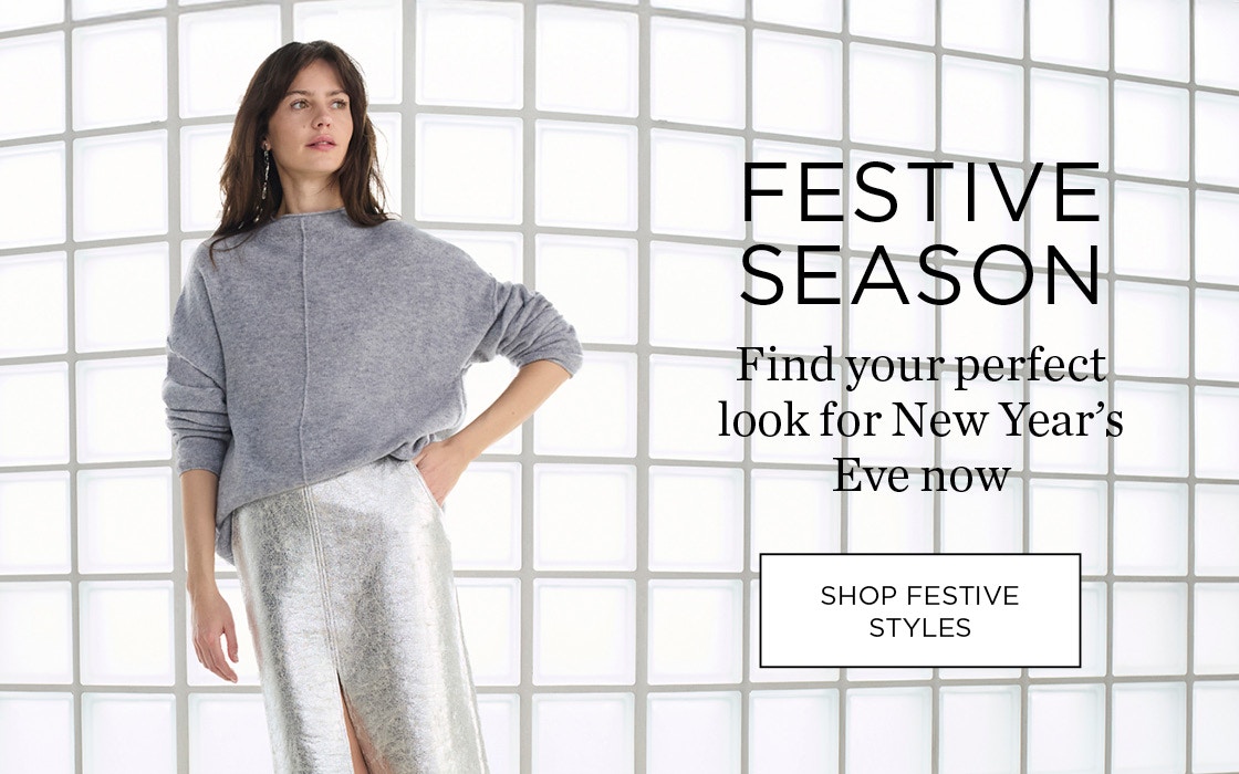 Woman wearing a grey jumper and silver skirt, Festive Season find your look for New Year's Eve.