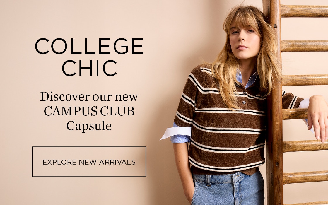 The woman wears a terrycloth jumper in brown with white stripes and a polo shirt collar. Underneath, she wears a blue blouse with white cuffs, and jeans complete the look.