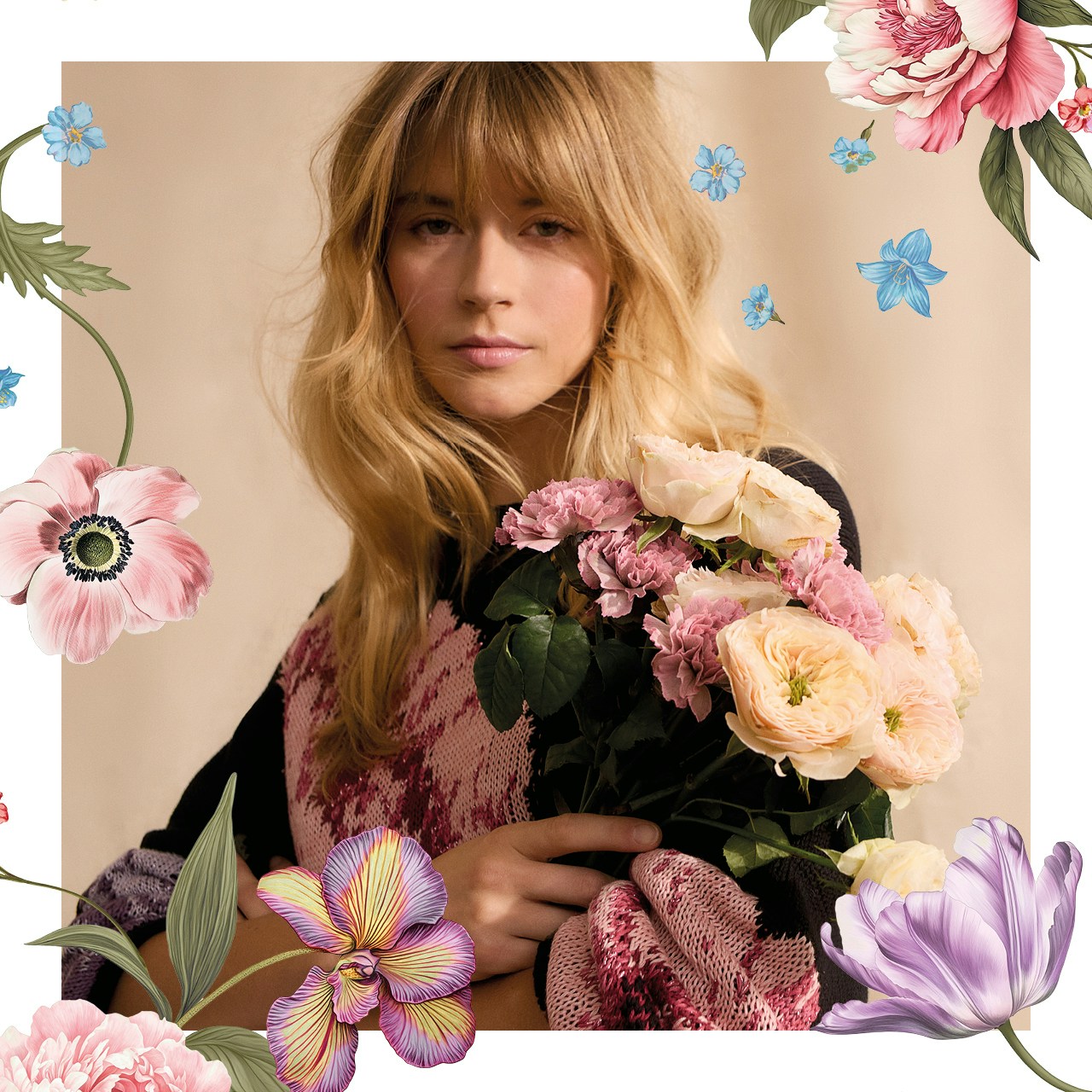 Woman wearing a black jumper with a colourful floral print.