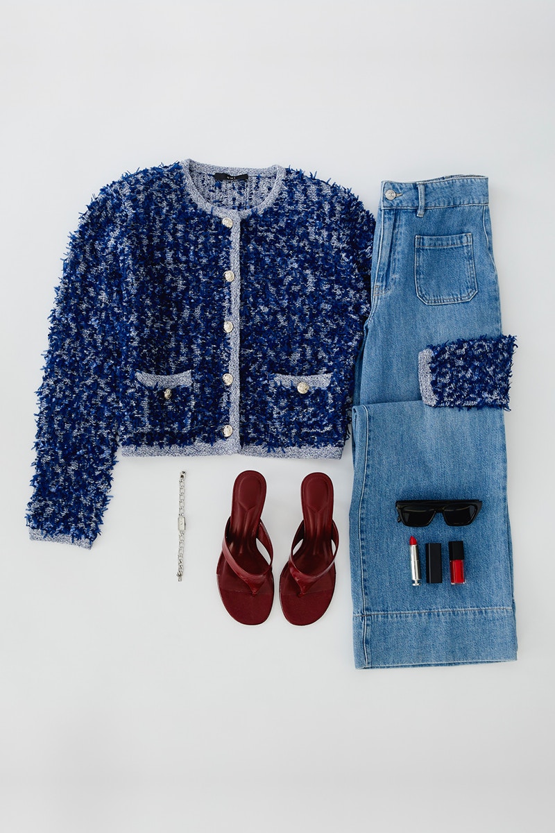 Clothes laid out: on the left, a blue French jacket with sandals; on the right, a pair of folded jeans.