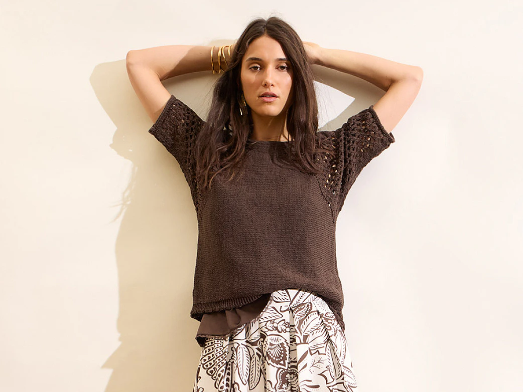 Model trägt braunen Pullover mit Midirock mit Print