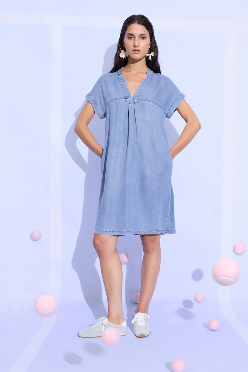 A woman is wearing a denim dress