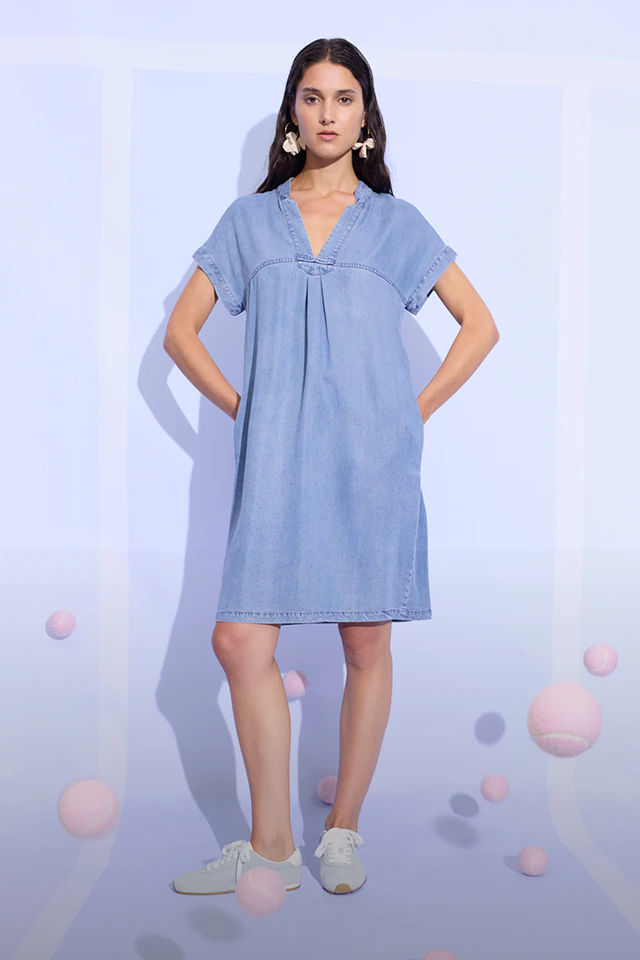 A woman is wearing a denim dress