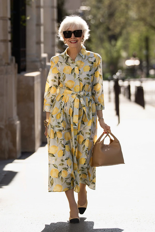 Alexandra Lapp’s mother is wearing a long-sleeved midi dress with an all-over lemon print.