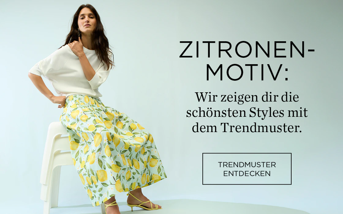 Frau mit weißem Pullover und Midirock mit Zitronendruck. Rechts Schrift: Zitronen-Motiv: Wir zeigen dir die schönsten Styles mit dem Trendmuster. Klickfläche: Trendmuster entdecken