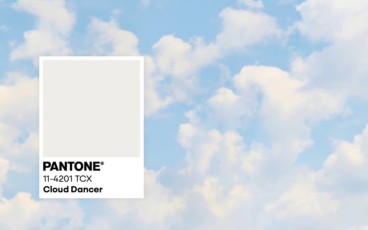 Ein Wolkiger Hintergrund mit links einer Farbpantone unter der Cloud Dancer steht.