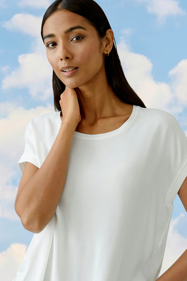 The woman is wearing a white shirt.