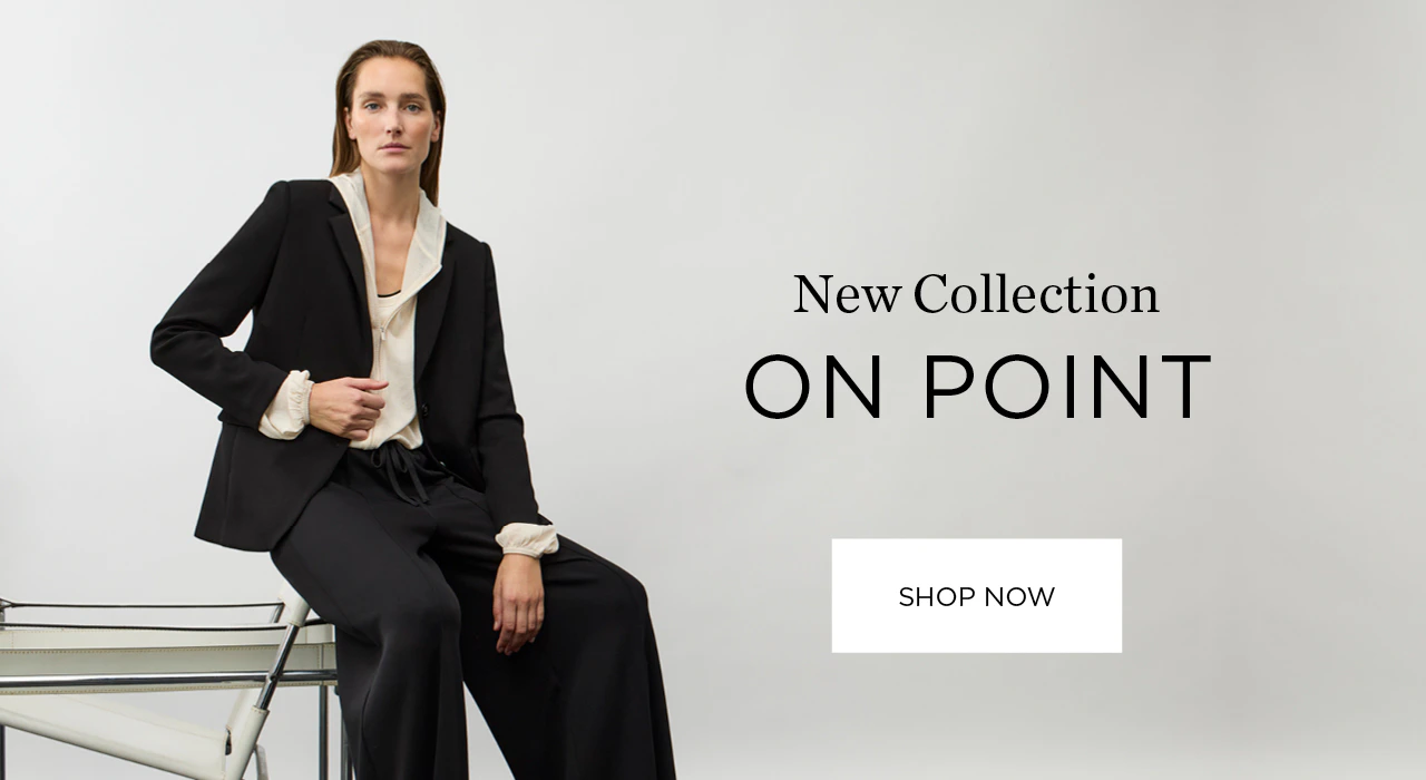 Model wearing a black trouser suit with a white hooded blouse. Caption: New On Point collection. Shop now.