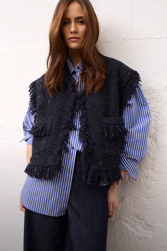 Women’s fashion from Oui, featuring a striped blouse, a dark blue waistcoat and matching trousers.