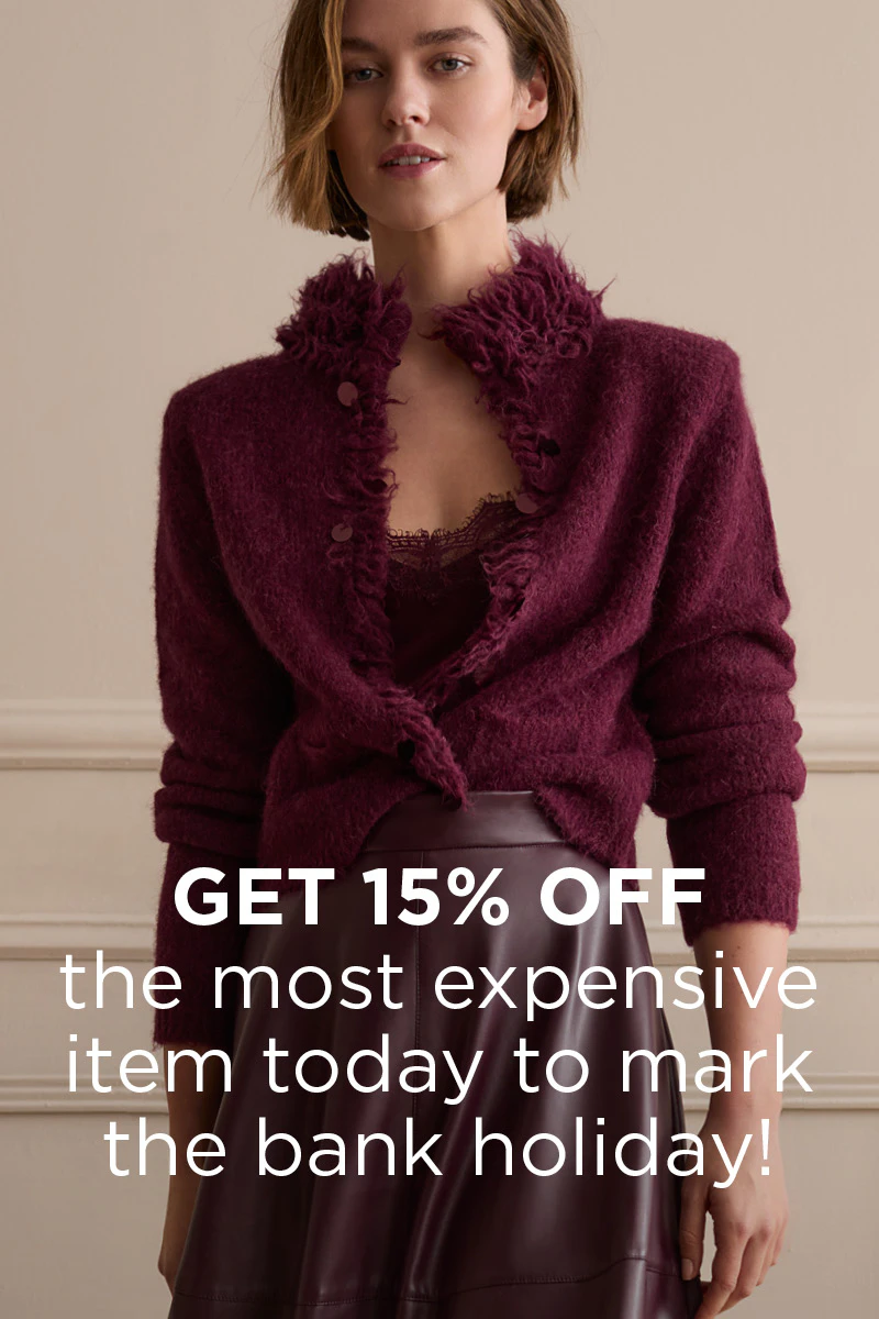 Burgundy women's fashion: Model wearing a cosy cardigan with a faux-fur collar over a lace top, paired with a glossy leather skirt. Text overlay: “Get 15% off your most expensive item today for the holiday!”