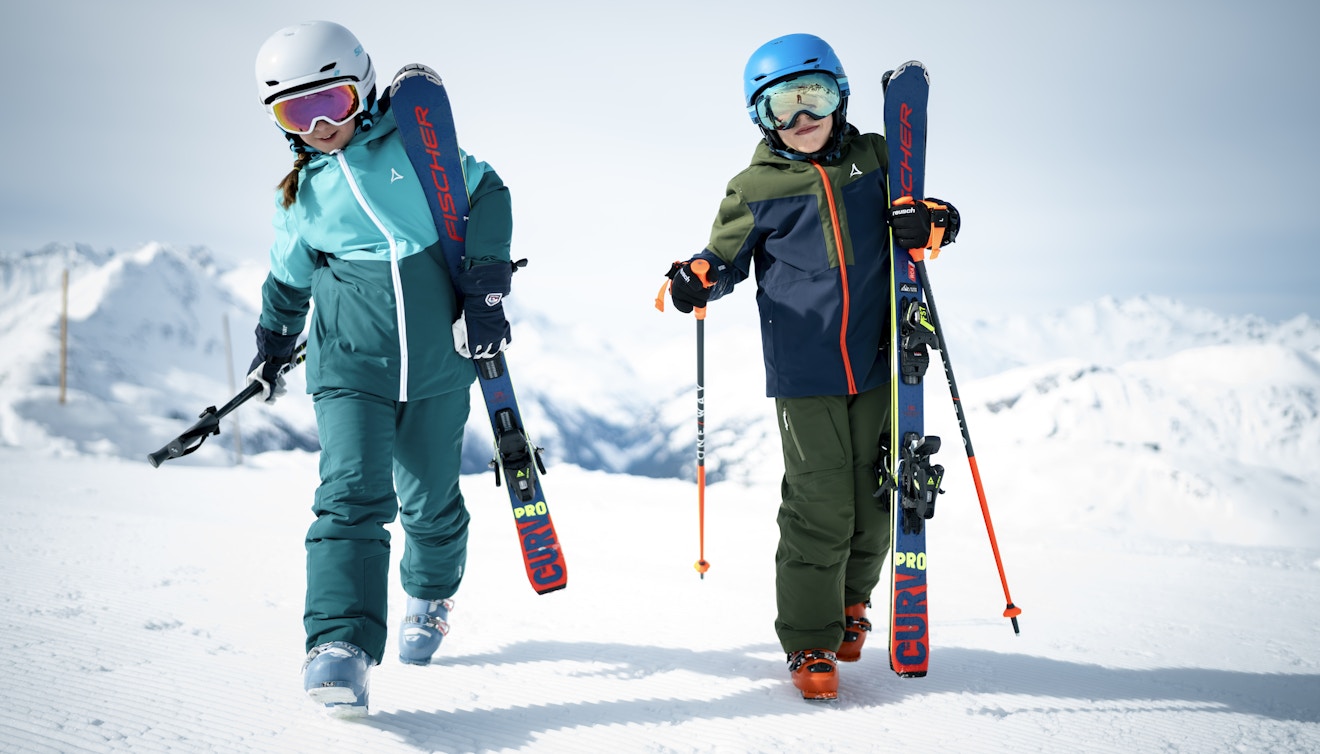 Skifahren lernen; zwei tragen ihre Ski; Schöffel