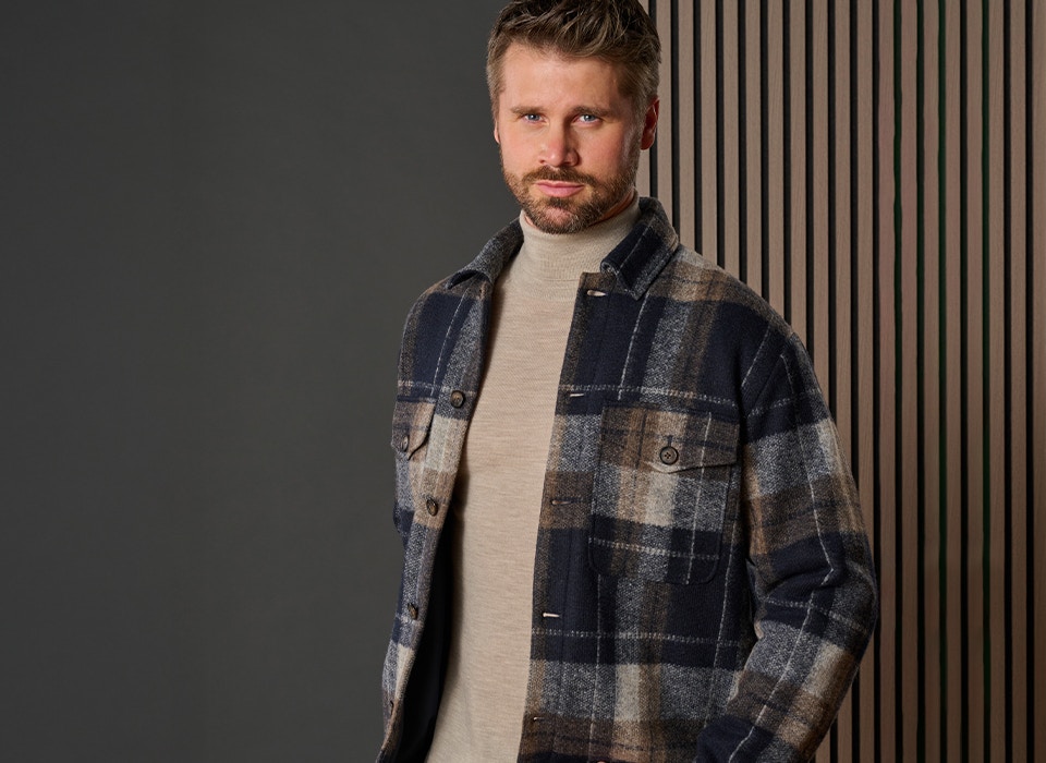 Thore Schölermann mit einer karierten Hemdjacke und einem beigen Rollkragenpullver von VENTI