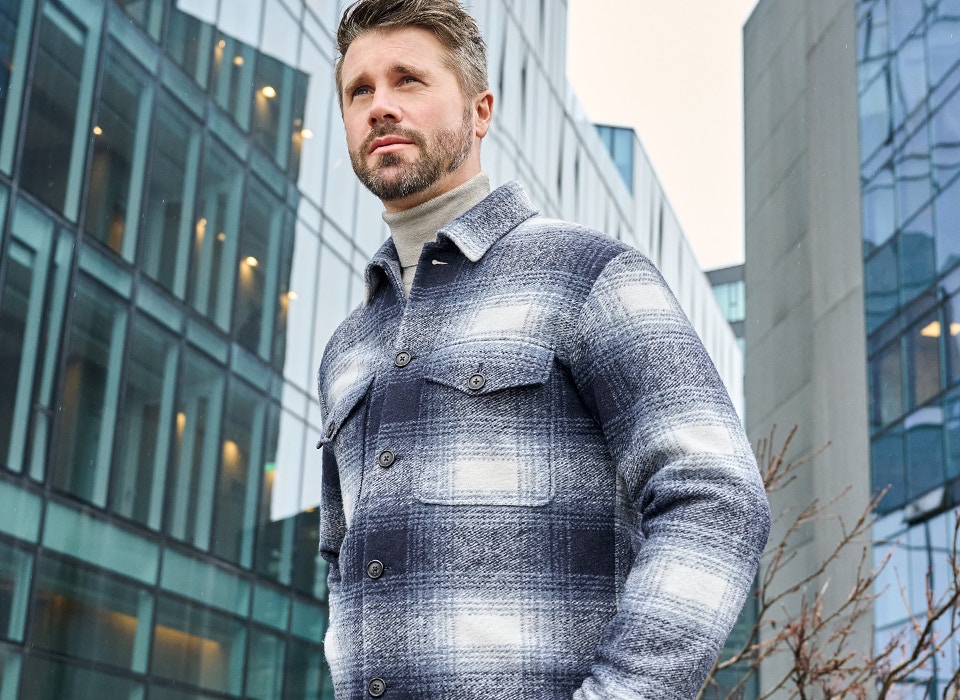 Thore Schölermann posiert mit einer blauen karierten Hemdjacke von VENTI