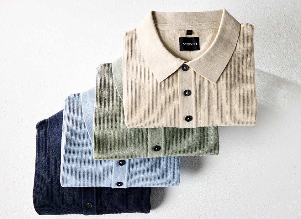 Langarm-Poloshirts in Beige, Grün, Hellblau und Dunkelblau liegen gestapelt.